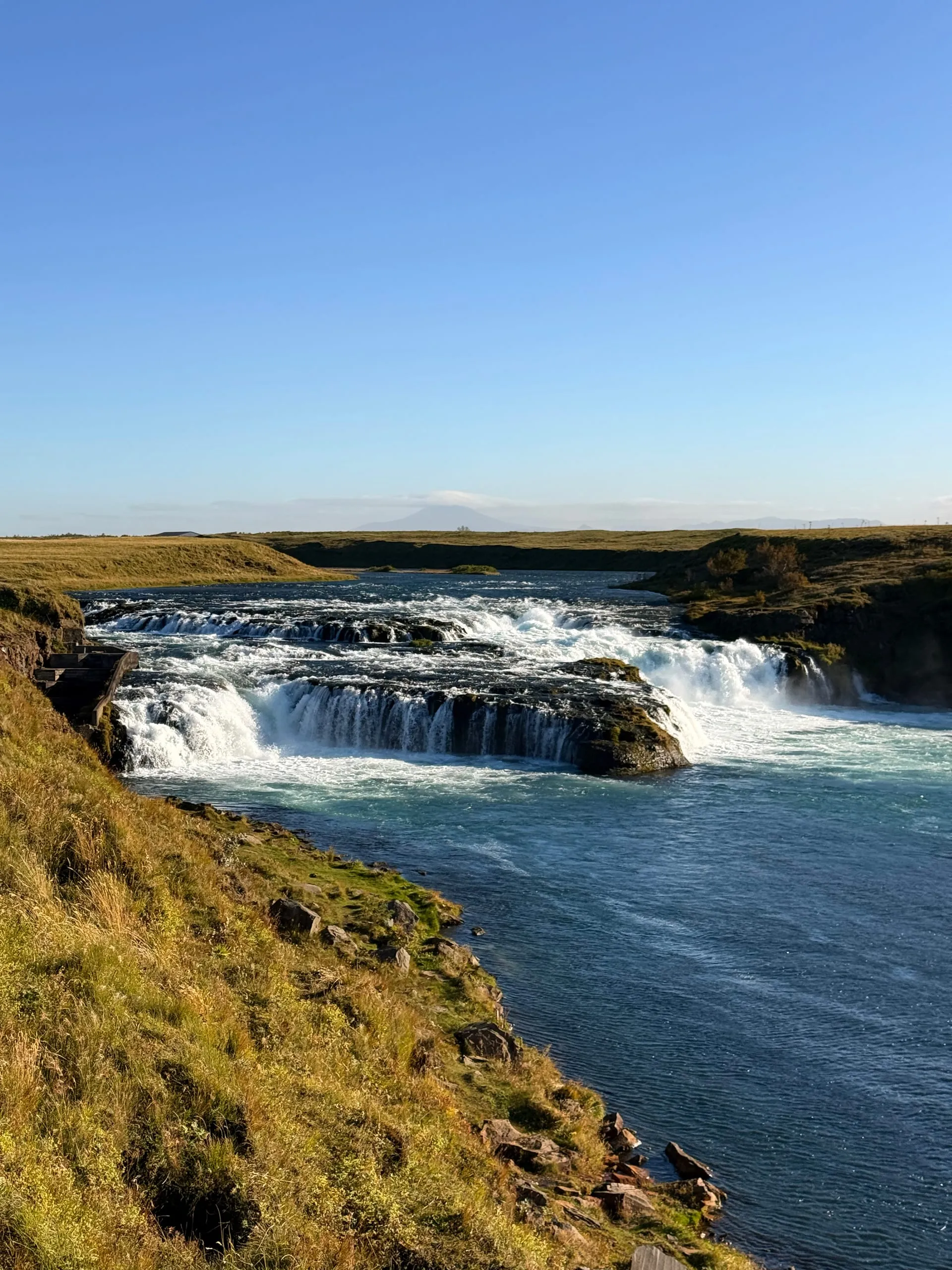The first pull-over of the first morning — a wide low falls on a lowland river, somewhere east of Hella