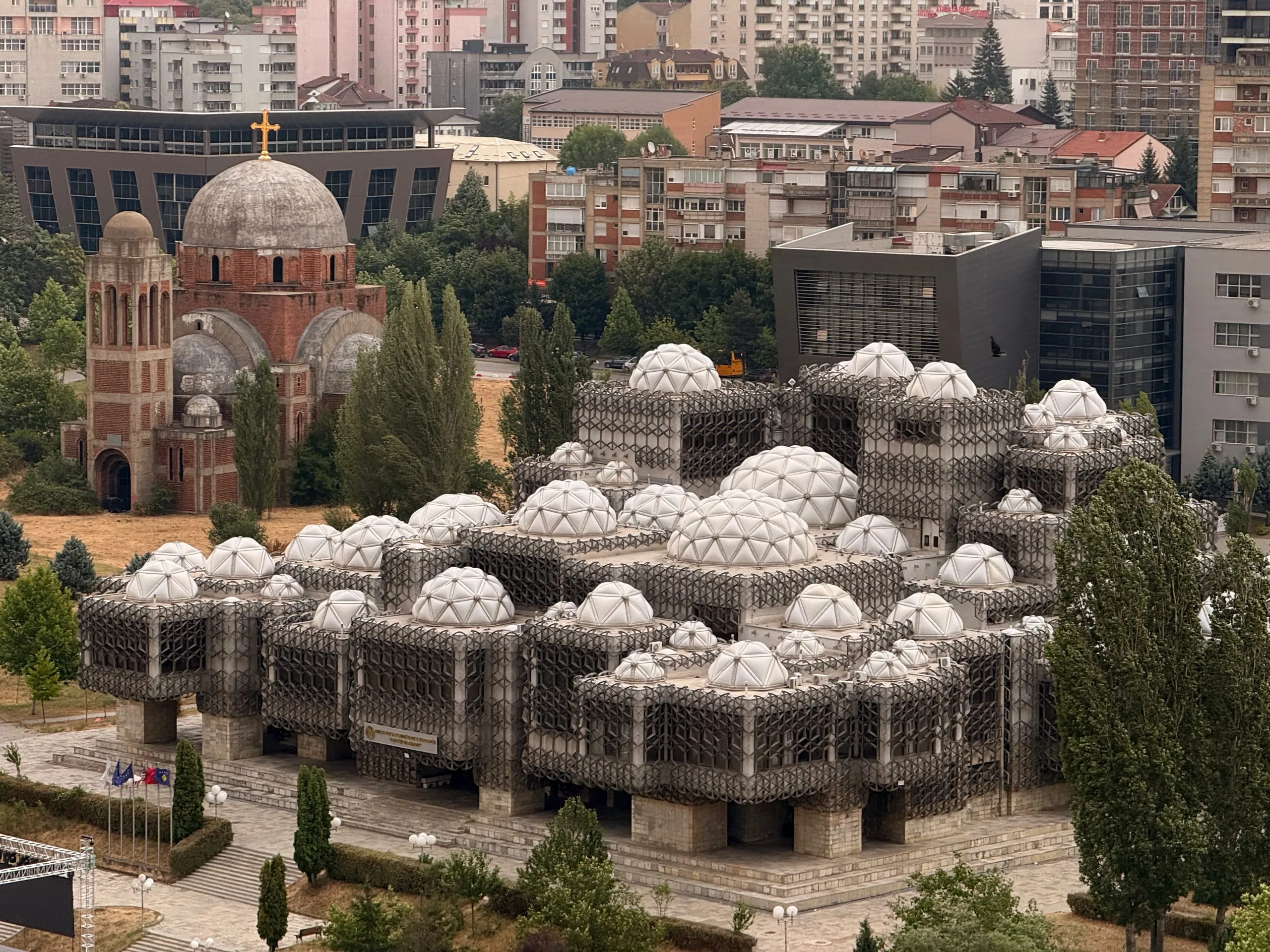 The National Library of Kosovo seen whole, its ninety-nine domes above Pristina