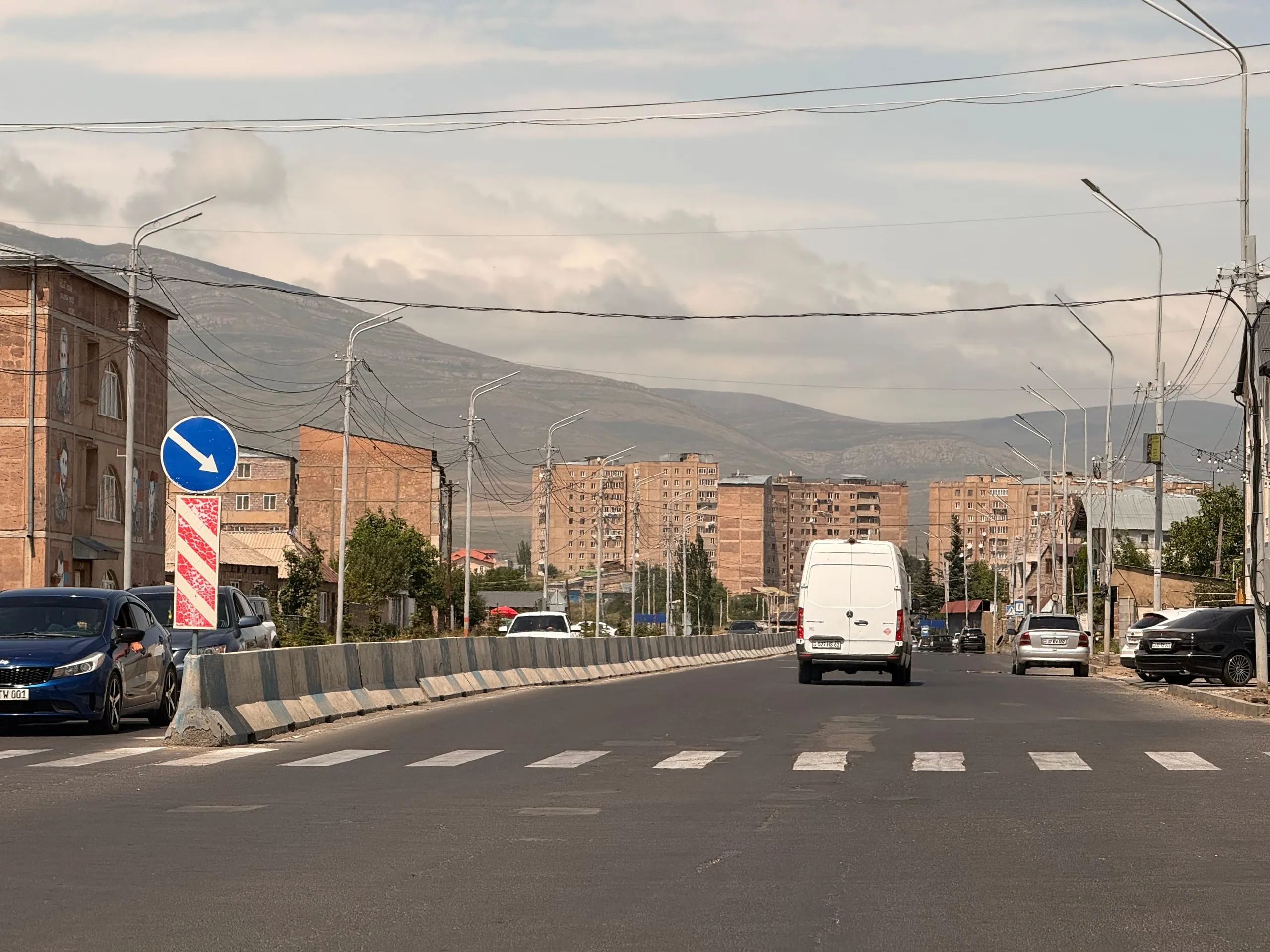 The road at Hrazdan — Soviet blocks either side, mountains ahead, seventeen hundred metres up